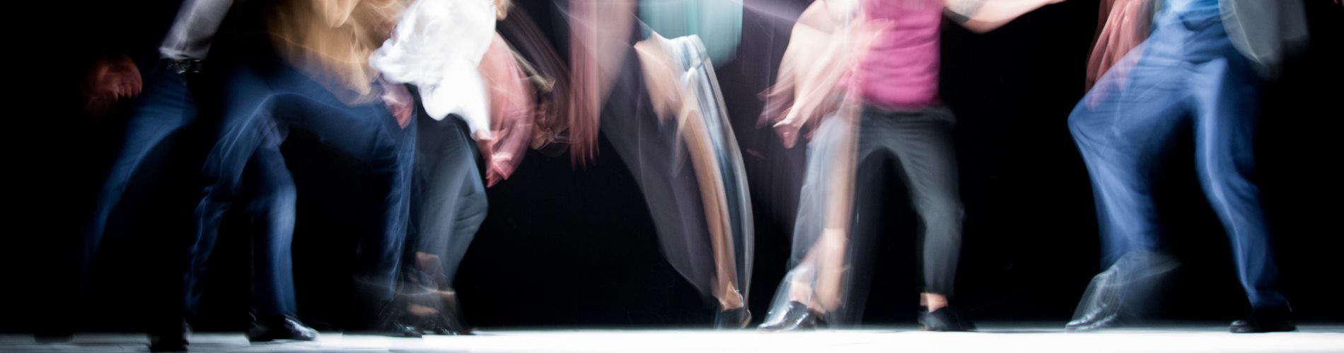 Conscious dance; people's feet on a dance floor